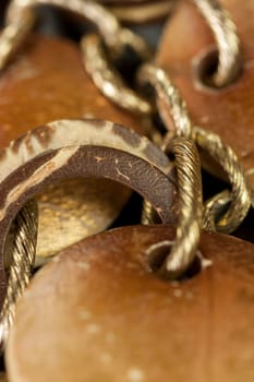 Bracelet or necklace with copper colored round pendants as close-up on dark background