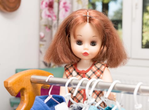 doll with red hair and several dresses