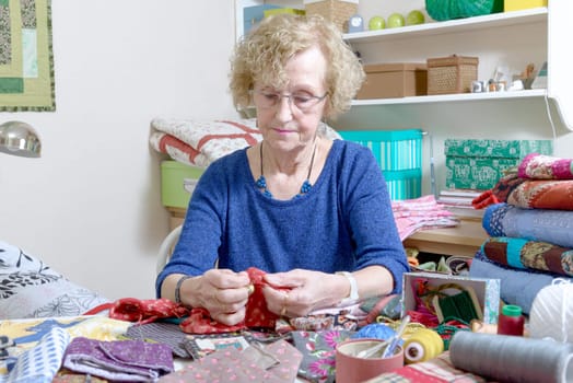dressmaker working on her quilt in his workshop