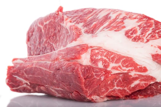 Fresh beef on a piece of roast beef greasy mixed marbled insulated on white background