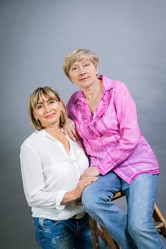 older adult happy wife mother with adult daughter portrait generation against grey background