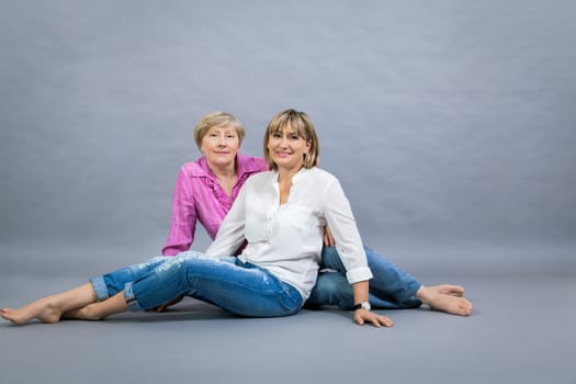 older adult happy wife mother with adult daughter portrait generation against grey background