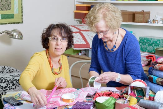 two women working on their patchwork in the workshop