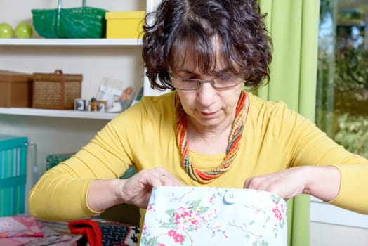 portrait of a seamstress dressed in yellow in his workshop