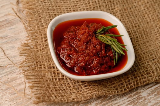 Red pesto on a rustic kitchen decoration