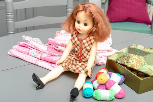 doll with red hair sitting on a table