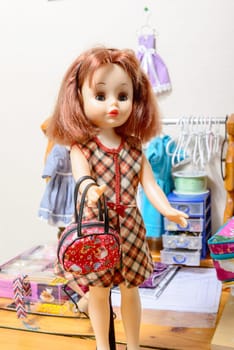 doll with red hair with a handbag