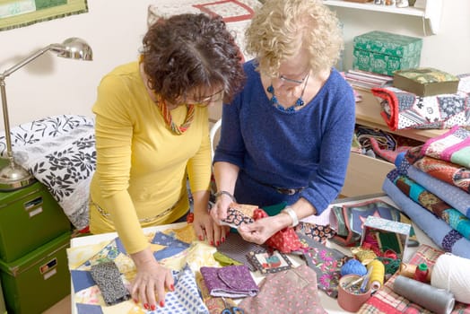 two women working on their patchwork in the workshop