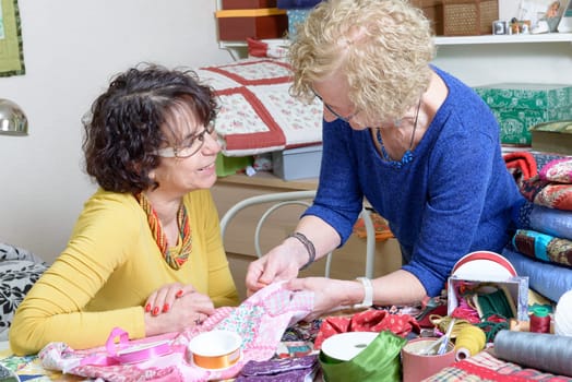 two women working on their patchwork in the workshop
