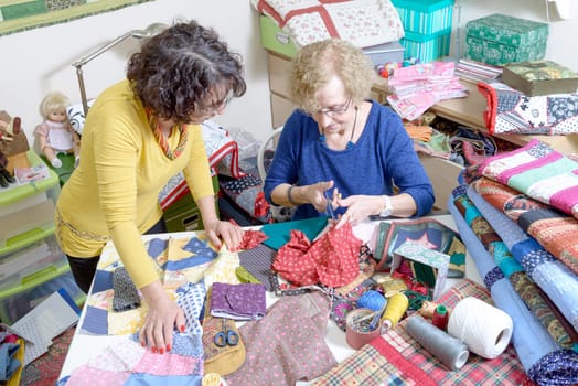 two women working on their patchwork in the workshop
