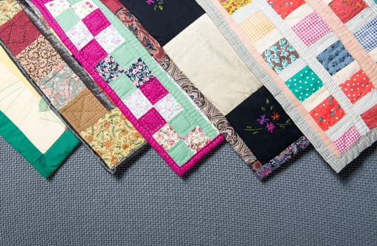 a patchwork  with different colored patterns  on grey background