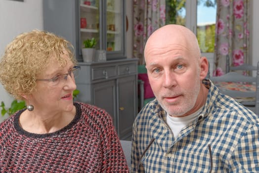 portraits of the mother and her adult son in his home