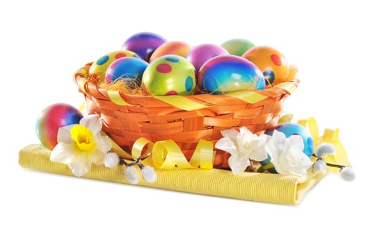 Colourful Easter basket with painted Easter eggs,daffodils and palm kittens