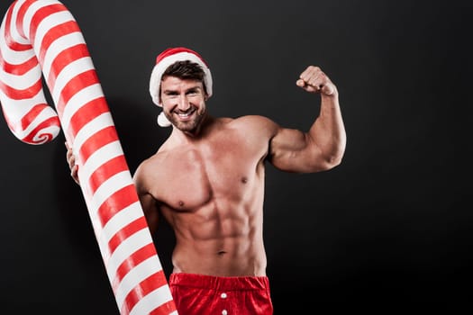 Masculine santa claus with christmas candy cane