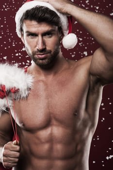 Manly and muscular santa claus with christmas presents