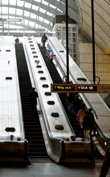 London,Uk - November 29,2014: People leave Canary Wharf Tube station via an escalator on November 29,2014 in London.