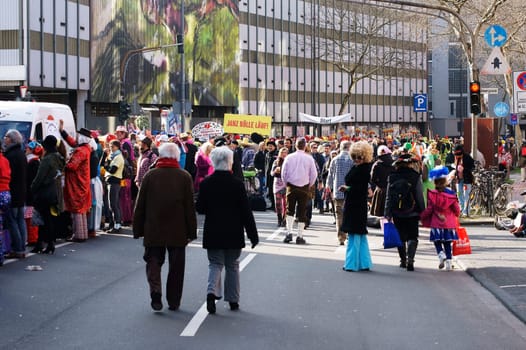 Cologne,Germany – March 02,2014: Colourfully dressed people wearing masks,wigs and costumes stand at the start of the carnival procession on March 2,2014 in Cologne.