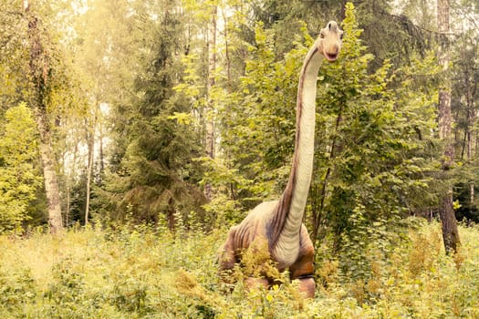Raubonys Park,Lithuania - 23 August 2017.Statue of Branchiosaurus dinosaur in a green forest