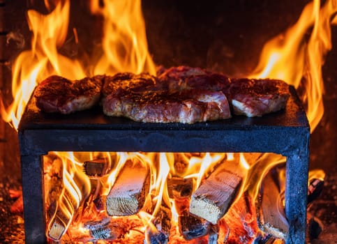 pork steaks preparing on the on a garden stone plate grill