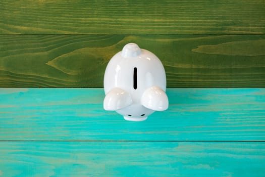 Piggy bank on color wooden background, financial investment concept