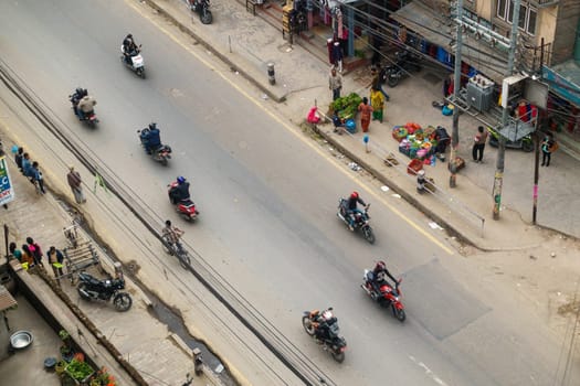 KATHMANDU, NEPAL - CIRCA APRIL 2016: Street aerial view with scooters, motorbikes vegetable vendors.