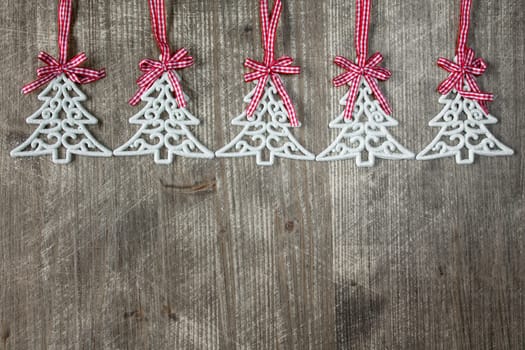 Fir tree shaped decorations on the wooden background with copy-space