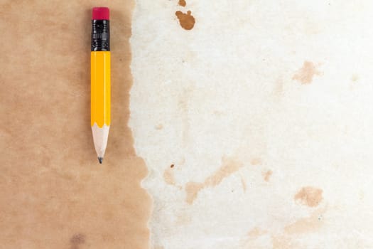 Piece of a old paper with a short pencil