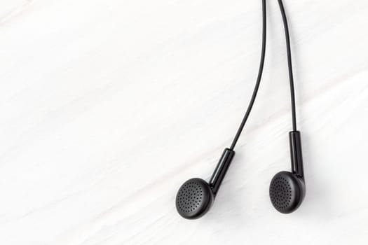 Earphones on wooden background with copy-space