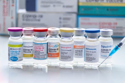Calgary, Alberta. Canada. Jan 31, 2021. Several covid-19 vaccines brands on vials bottles with a syringe.