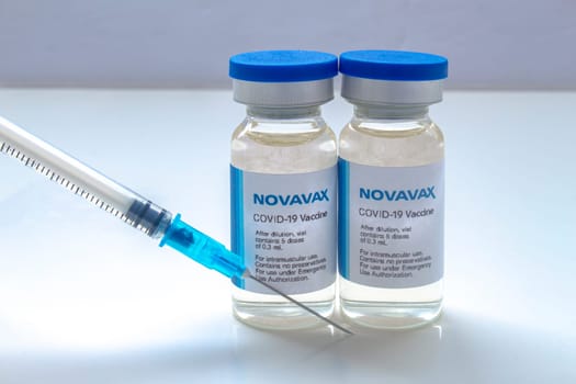 Calgary, Alberta. Canada. Jan 30, 2021. A couple of Novavax covid-19 vaccines with a syringe on a white background.