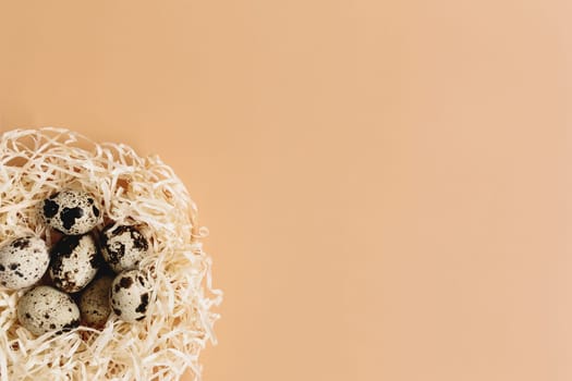 Artificial nest with quail eggs on beige background. High quality photo