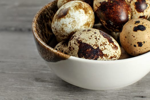 Detail on quail eggs in small bowl.