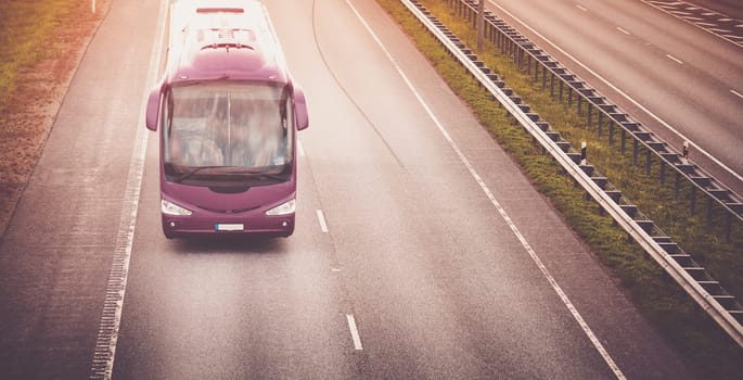 Bus on asphalt road in beautiful summer evening outdoors