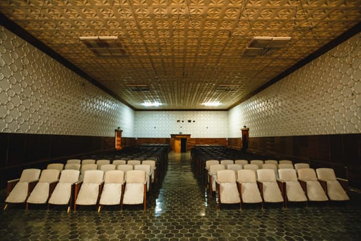 The auditorium in the village club. Ancient seats for spectators of the Soviet era.