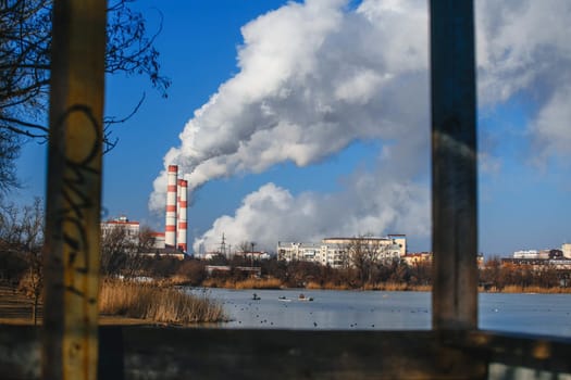 Thick white smoke from the pipes of boiler rooms and pipes of factories and factories.