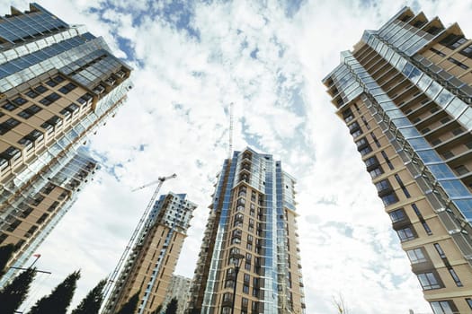 luxury residential high-rise buildings with mirrored glazing are under construction.