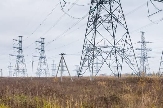 Power line supports. Electricity transmission and posts.