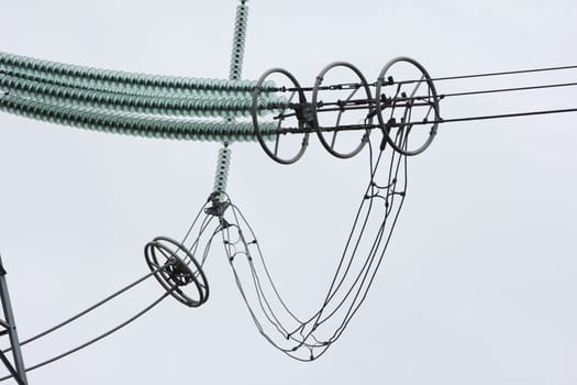 Glass insulators on high-voltage power line poles.