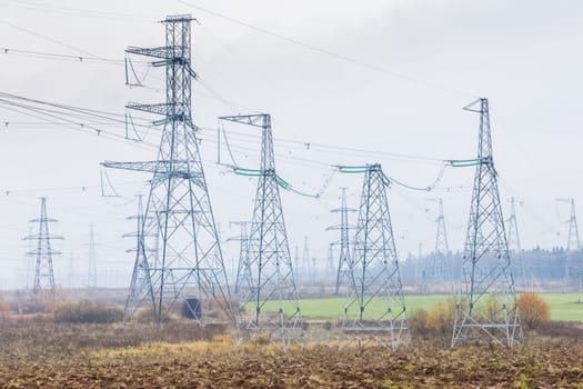 Power line supports. Electricity transmission and posts.