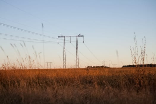 Power line supports. Electricity transmission and posts.