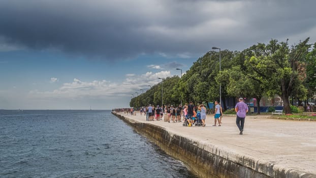 Zadar, Croatia, July 2019 Crowds of tourists walking and relaxing on the pier, Coast of King Petar Kresimir IV, towards Morske Orgulje, Sea Organs
