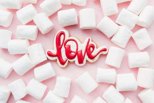Gingerbread cookies love with white marshmallow. Valentine card. Pink background. High quality photo