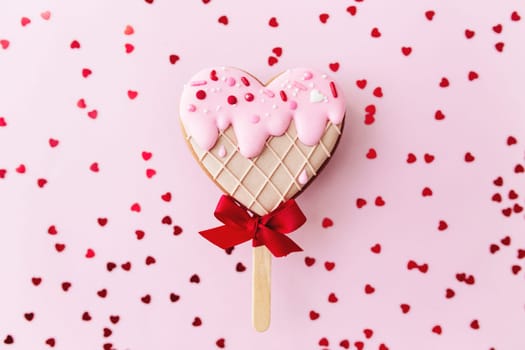 Melting ice cream heart gingerbread cookie. Valentine. Pink background, glitter. High quality photo