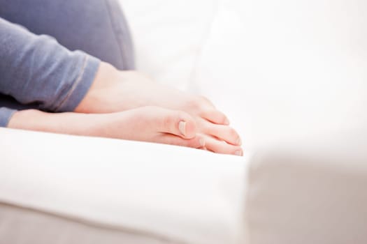 clean feet of a young woman sleeping on a white couch