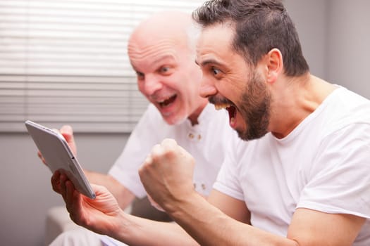 adult friends having fun like teenagers in a living room