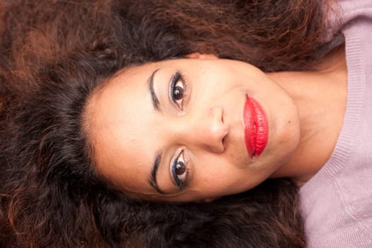 wonderful african-american woman lying on a sofa relaxing