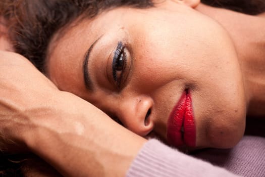 wonderful african-american woman lying on a sofa relaxing