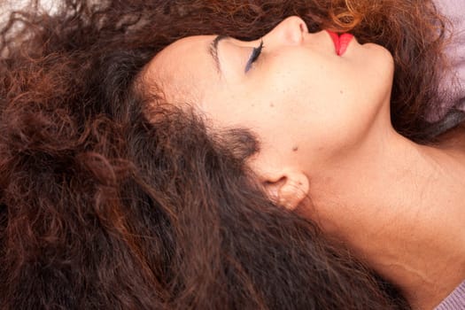 wonderful african-american woman sleeping on her sofa