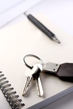 Diary, the handle and keys on a white background .