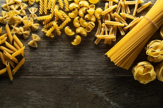 Pasta collection on rustic wooden background
